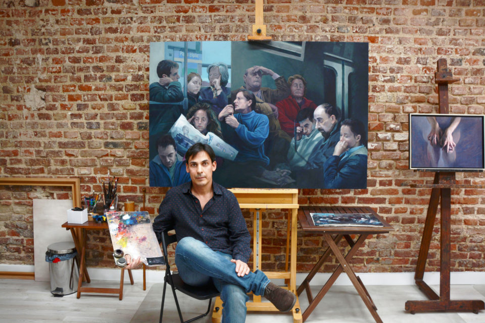 Cristian Avilés in his Spanish studio. In the back his last paintng "People in Subway". Photo by Jose Antonio Ramirez